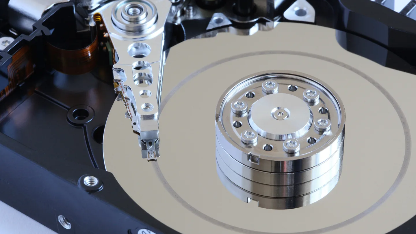 The inside of an opened hard disk drive, showing the platters and the read head