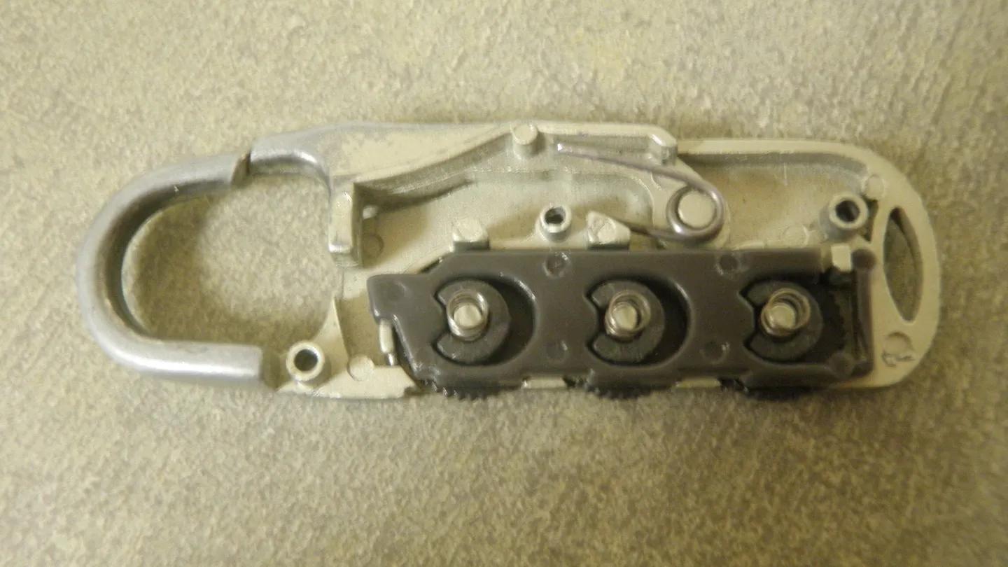 An open combination padlock with its shackle released